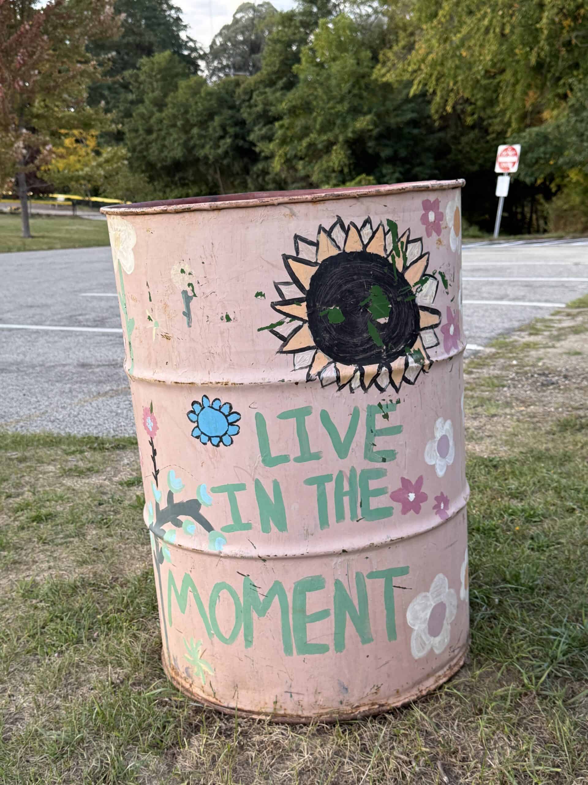 Barrel at Yarmouth elementary school that is painted with the saying "Live in the Moment"
